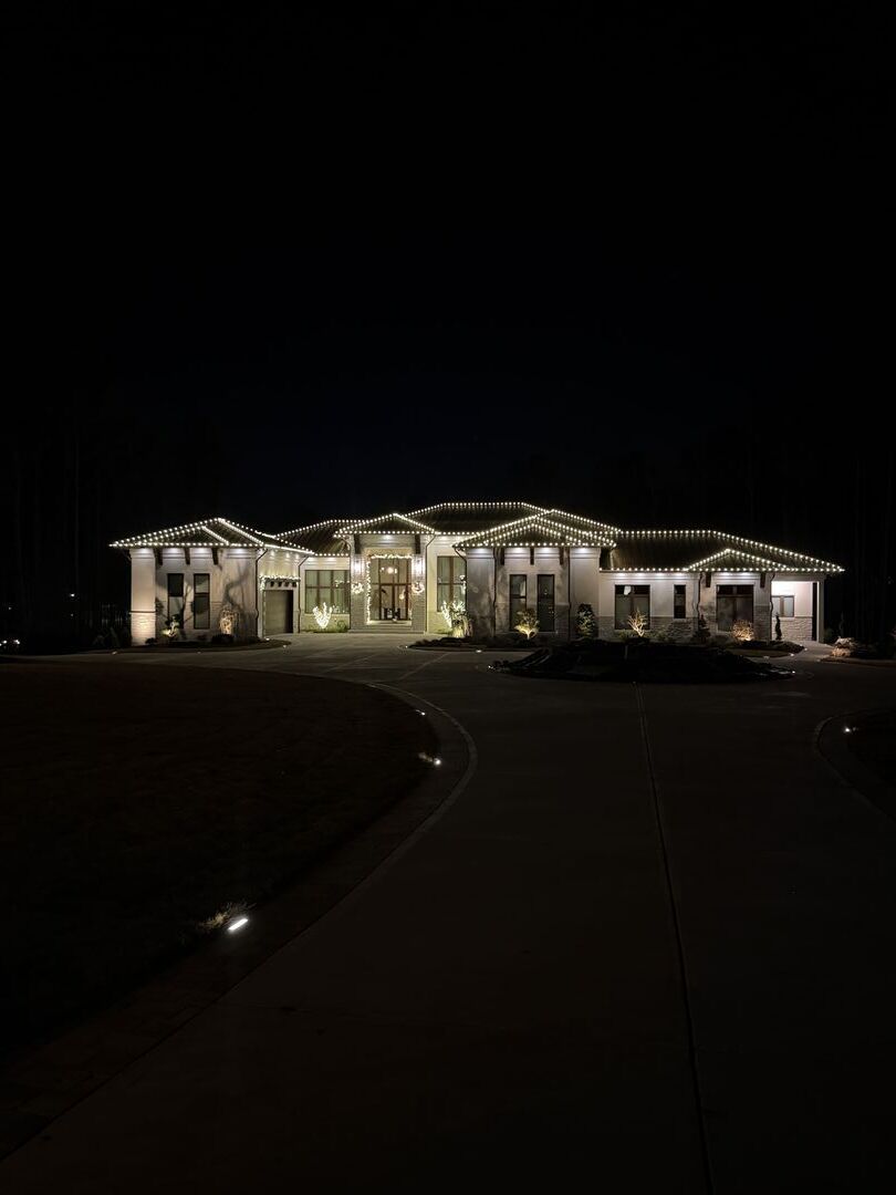 House decorated with Christmas lights at night.
