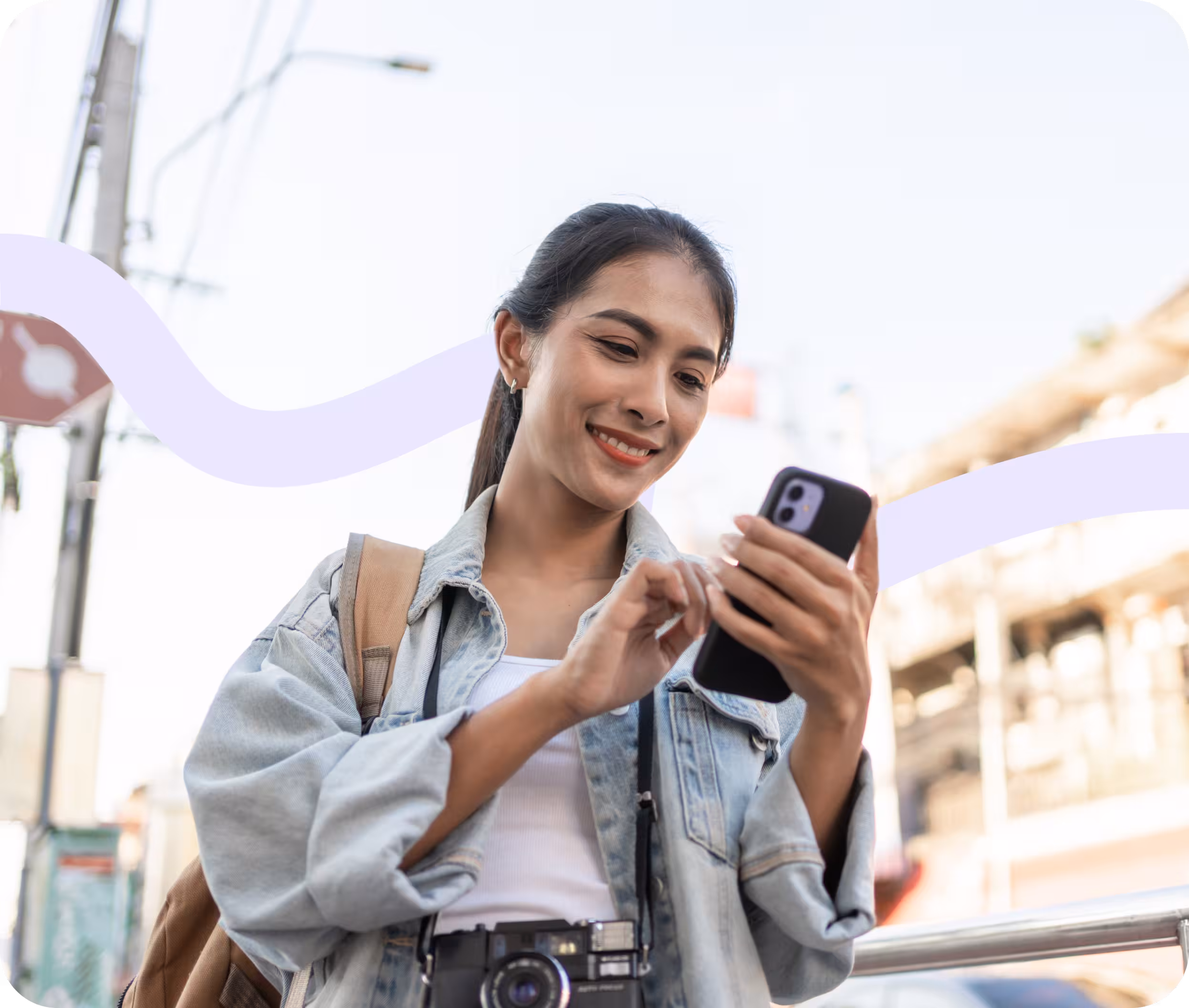 Young woman smiling while comparing personal loans on her phone