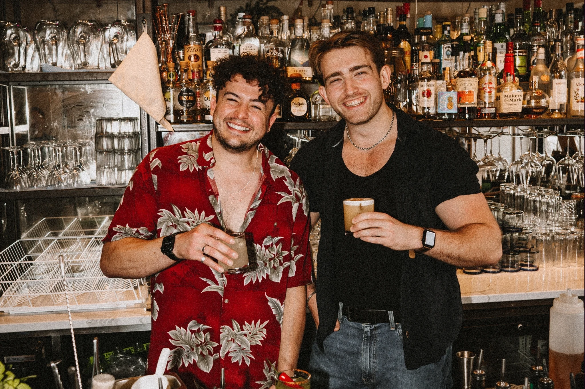 Bartenders smiling behind the bar