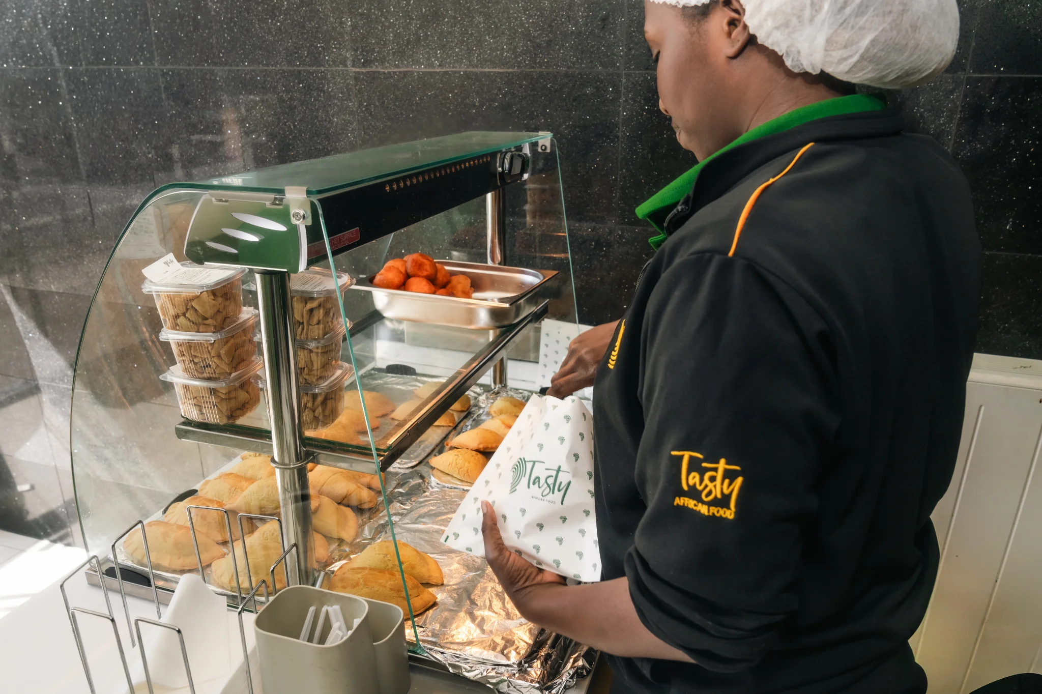 Tasty African Food employee preparing food for customers