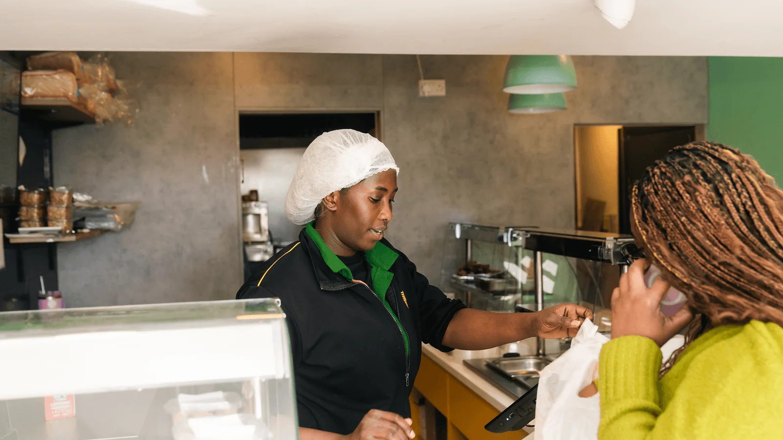 Restaurant employee serving customer