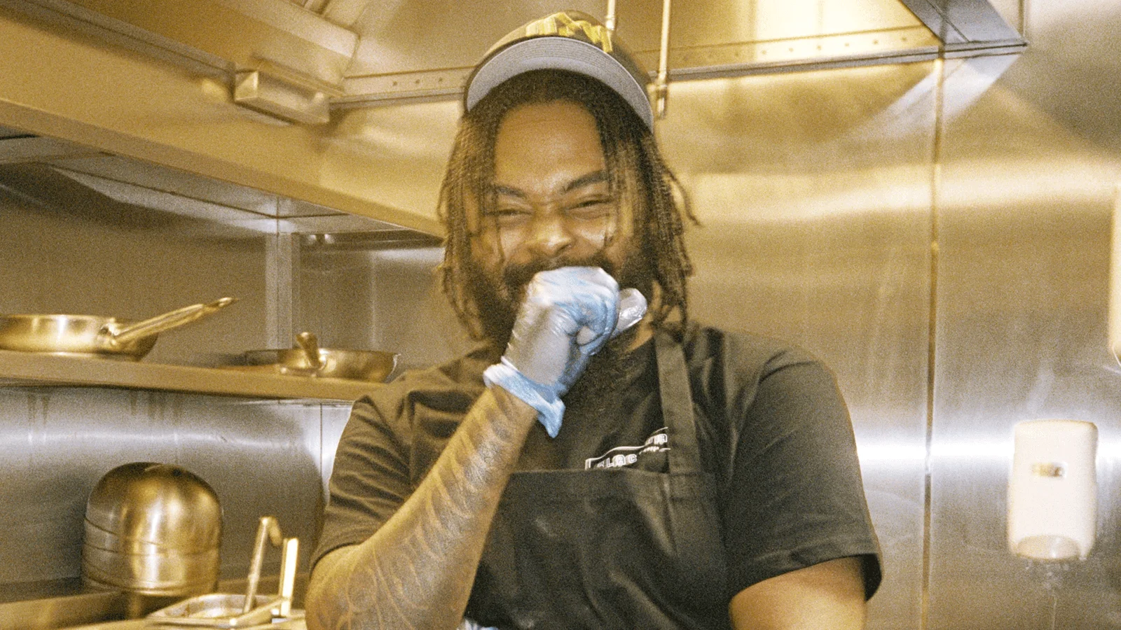 Restaurant employee smiling in the kitchen