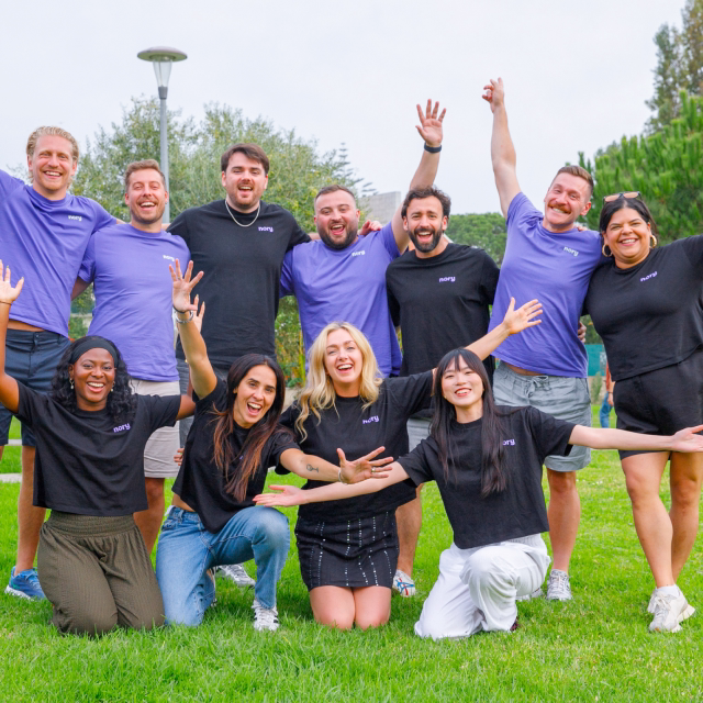 Nory team group photo with everyone celebrating outdoors