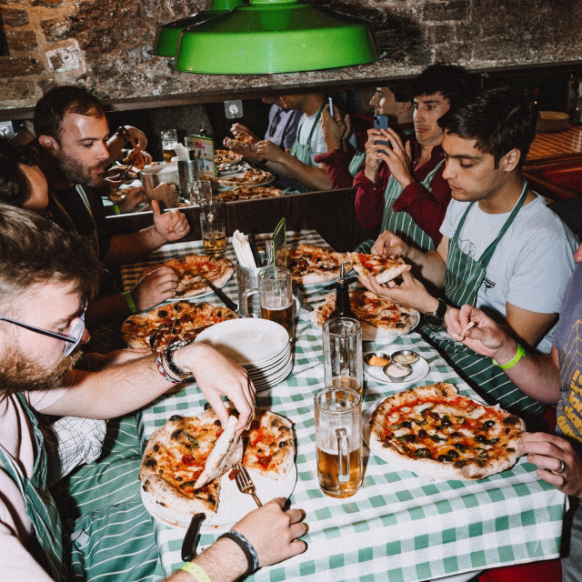 Nory team enjoying pizza together at a team dinner