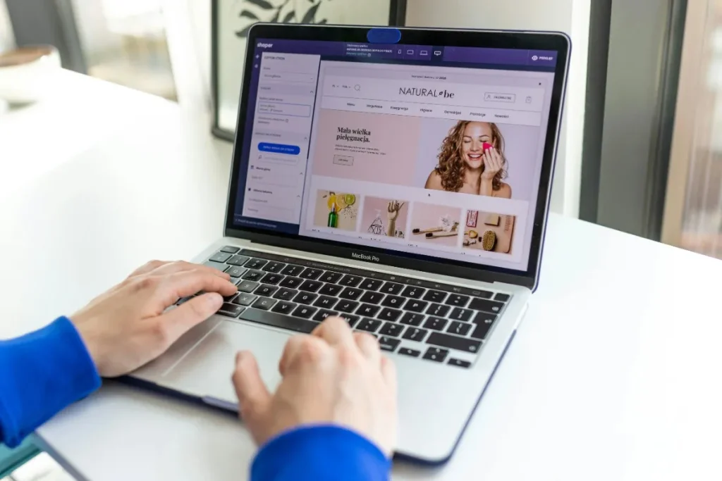 User browsing an e-commerce website interface on a laptop showing UX design and online store layout