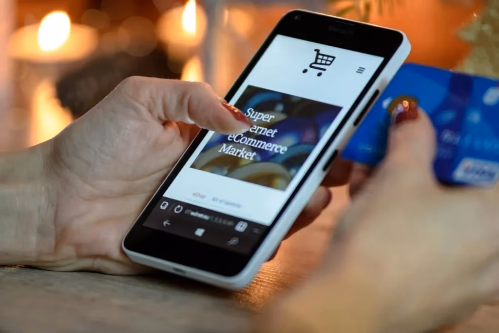 Customer browsing an ecommerce website and making a purchase on a smartphone using a credit card.