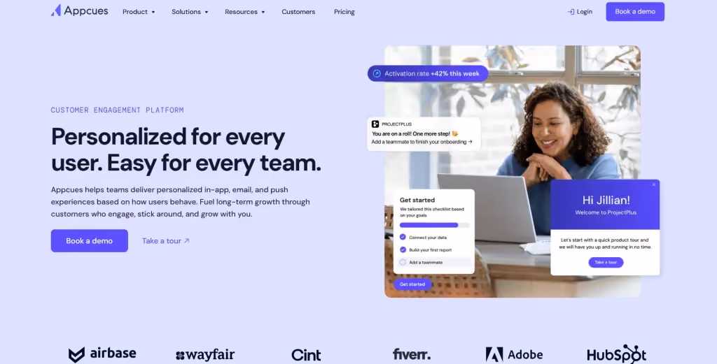 Appcues homepage showing its customer engagement platform with in-app onboarding messages, product tour prompts, checklist widgets, and brand logos including Adobe, HubSpot, Fiverr, Wayfair, and Airbase.