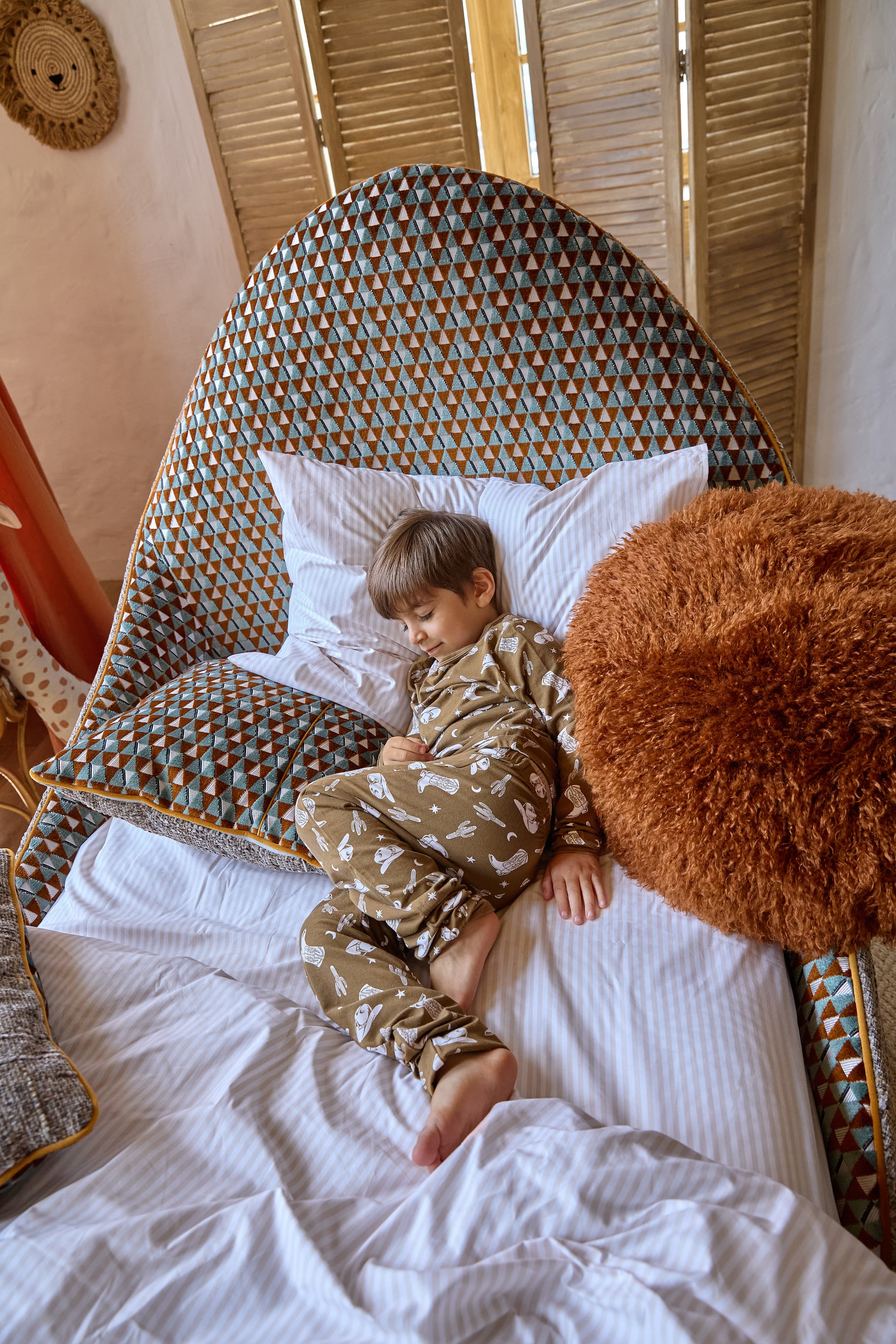 boy in a big checkered bed