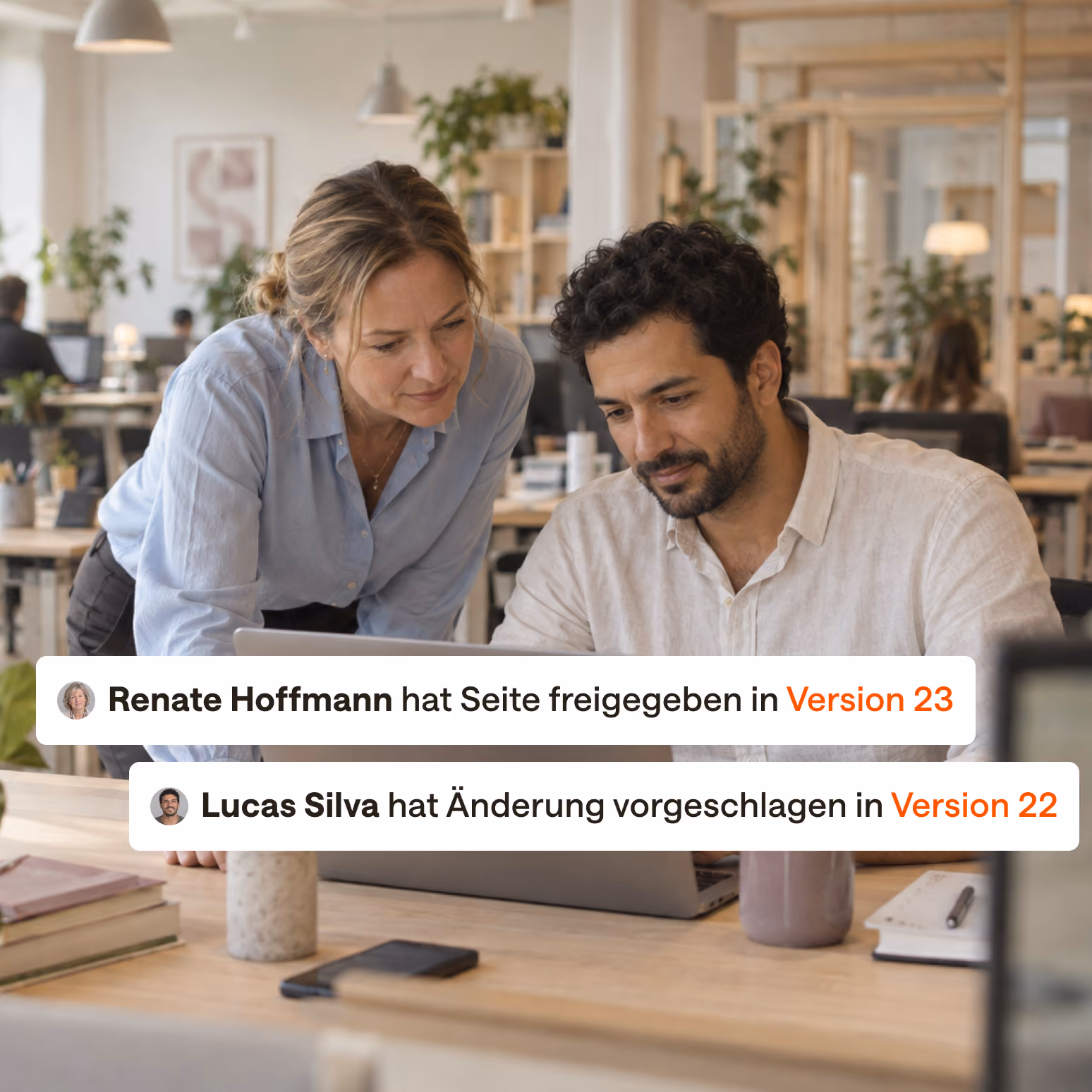 A woman and a man working on a laptop, suggesting and approving changes.