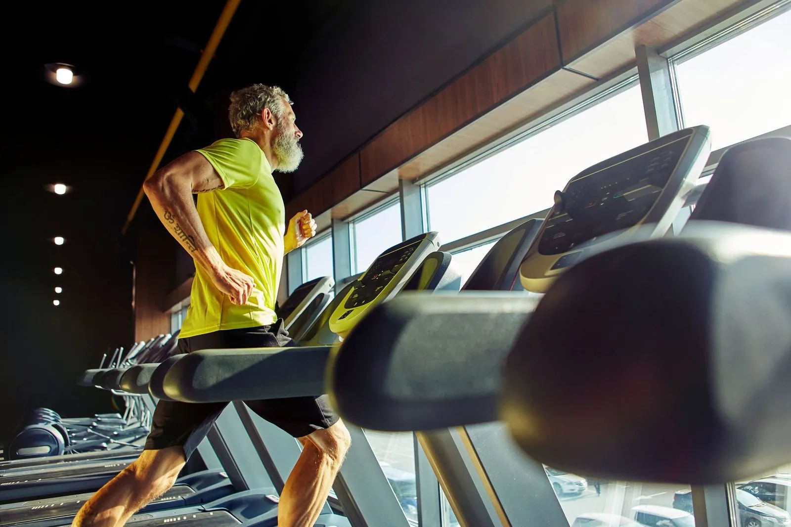 Older man running on a treadmill at the gym