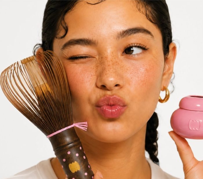 A model holding a direct-to-consumer beauty product