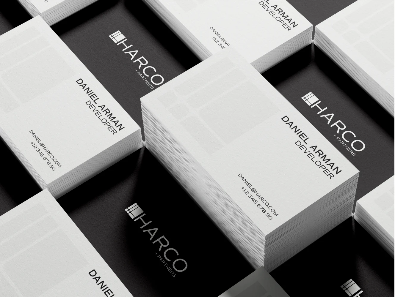 Stacked HARCO business cards in black and off-white