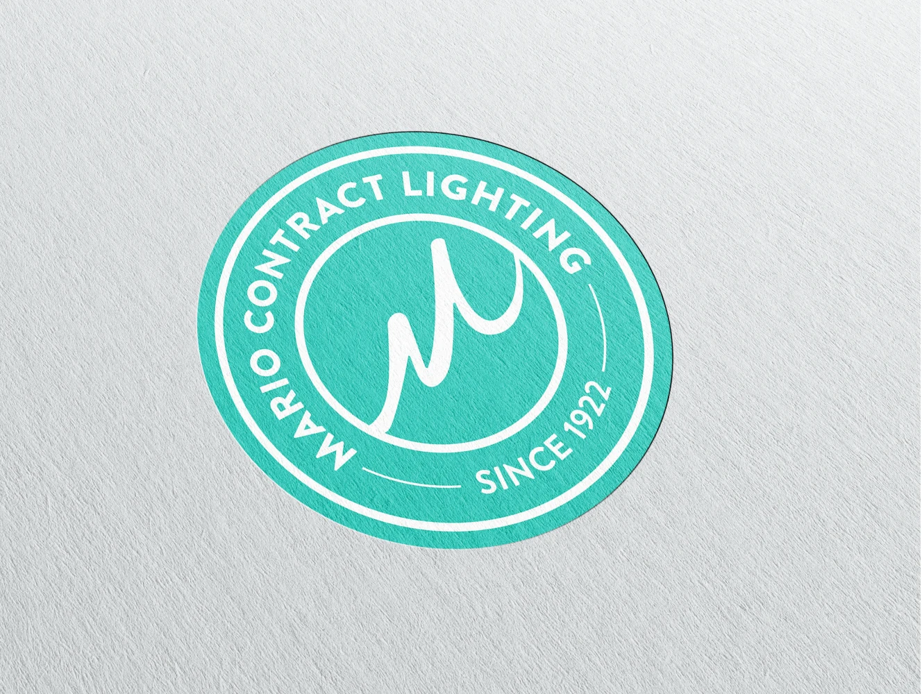 Mario Contract Lighting logo mark embossed on paper