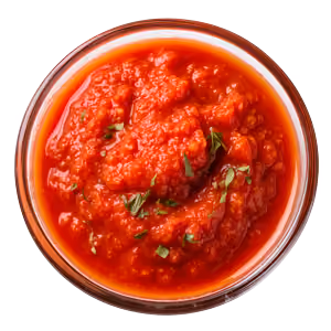 Top view of a glass bowl filled with chunky red salsa garnished with chopped herbs.