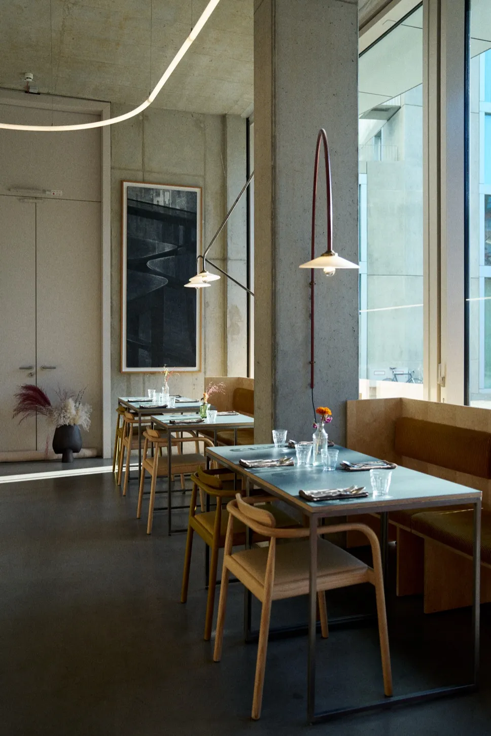 Remi dining room with set tables by the window