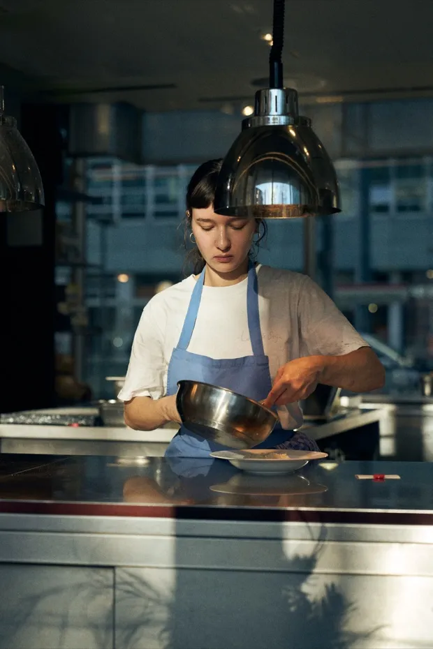 Chef plating dishes in the open kitchen