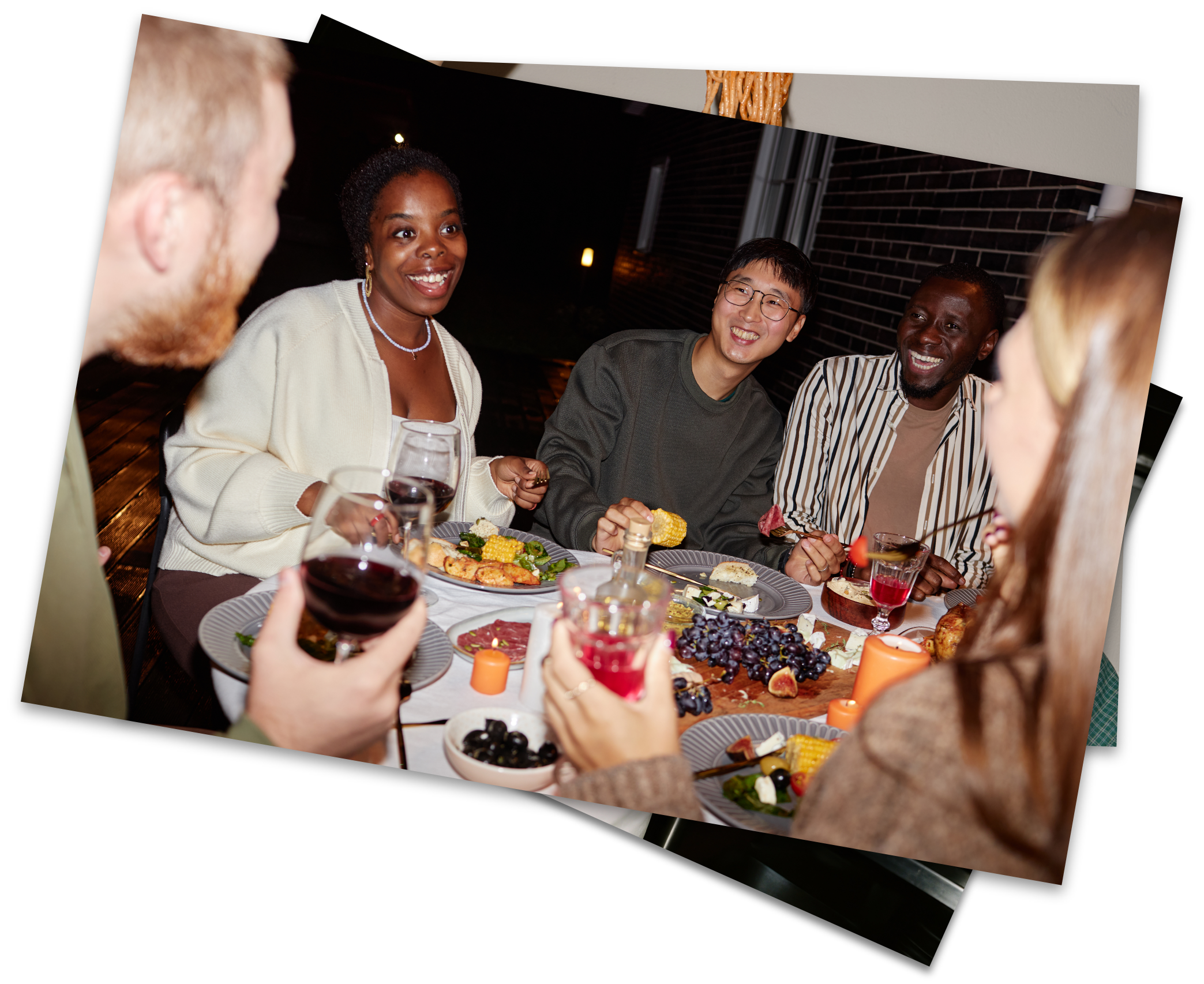 Friends gathered around a dinner table sharing food