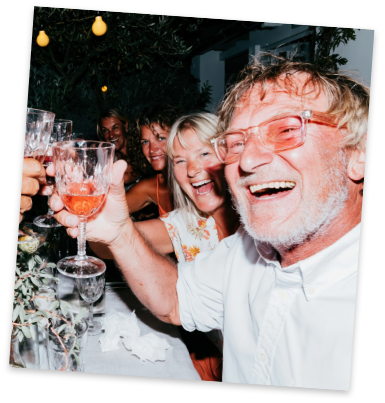 Friends toasting glasses at an outdoor dinner