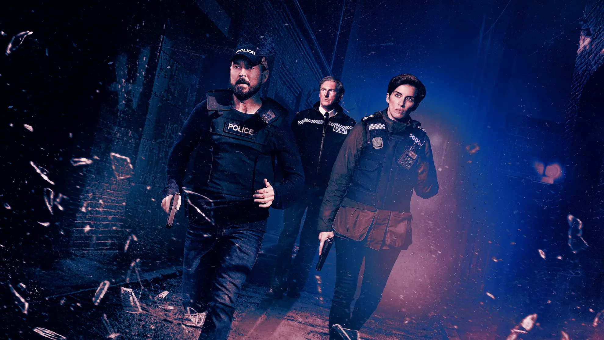 Three police officers walking purposefully through a dark, narrow alley at night, two holding guns and wearing tactical vests with 'POLICE' labels, with shattered glass fragments around them.