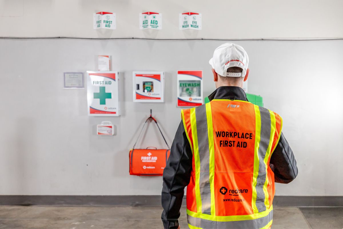 A Redicare representative servicing workplace first aid equipment