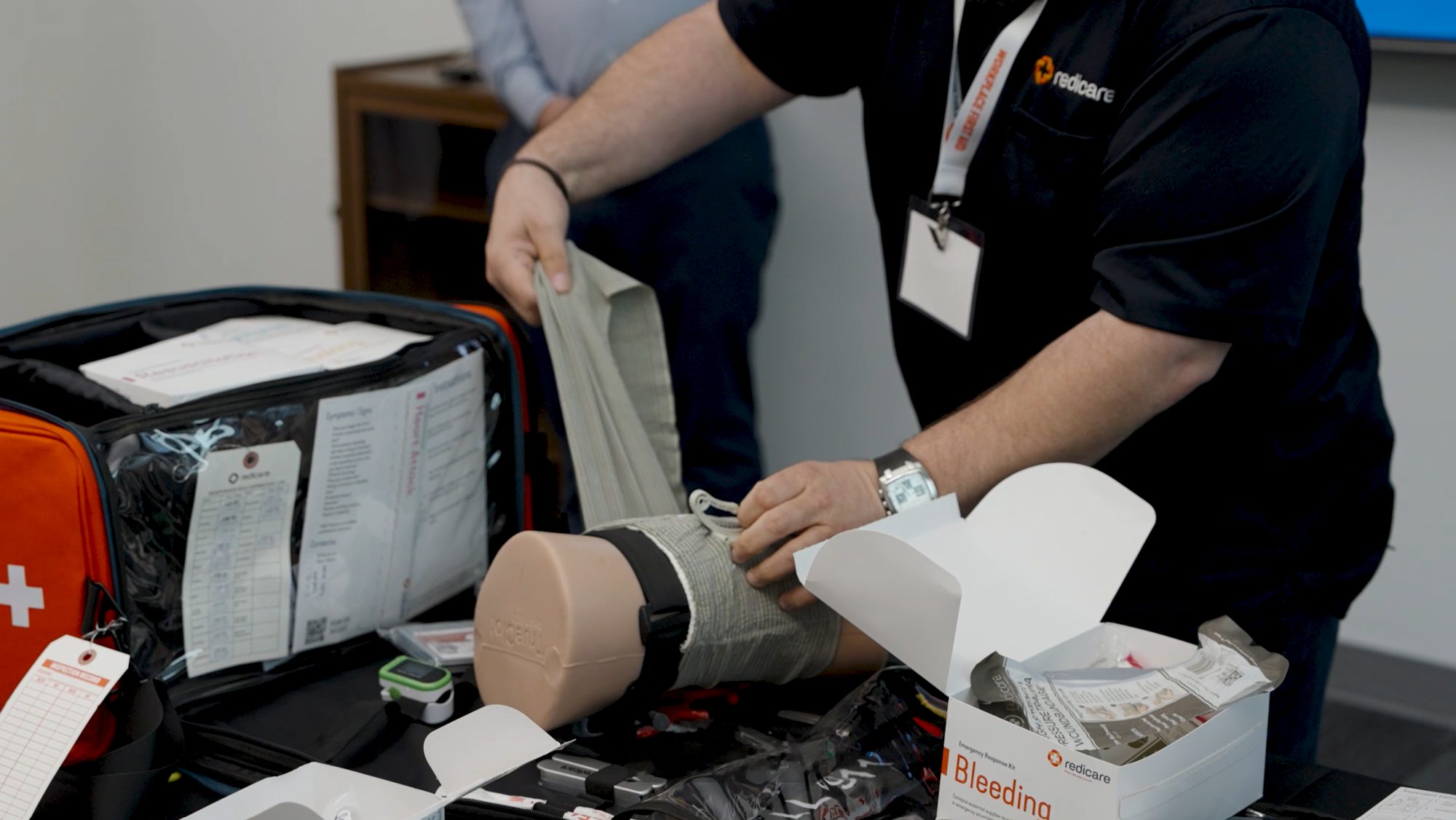 A Redicare trainer demonstrating how to apply a bandage