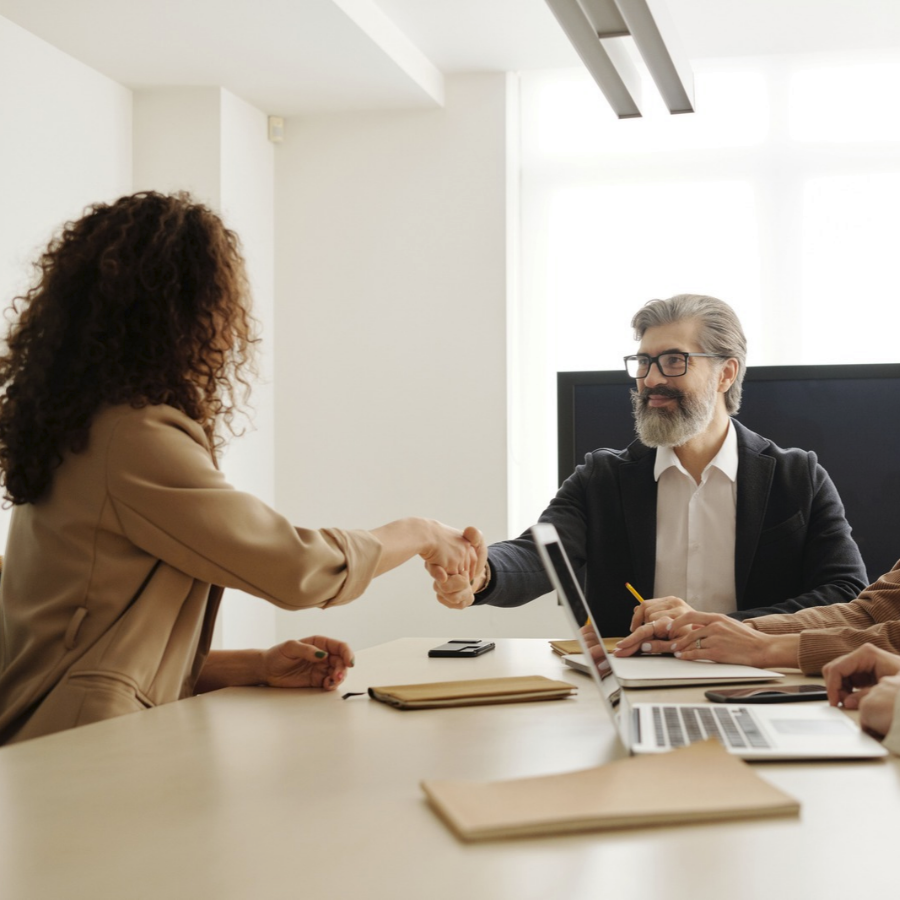 An HR professional shaking hands with a coworker
