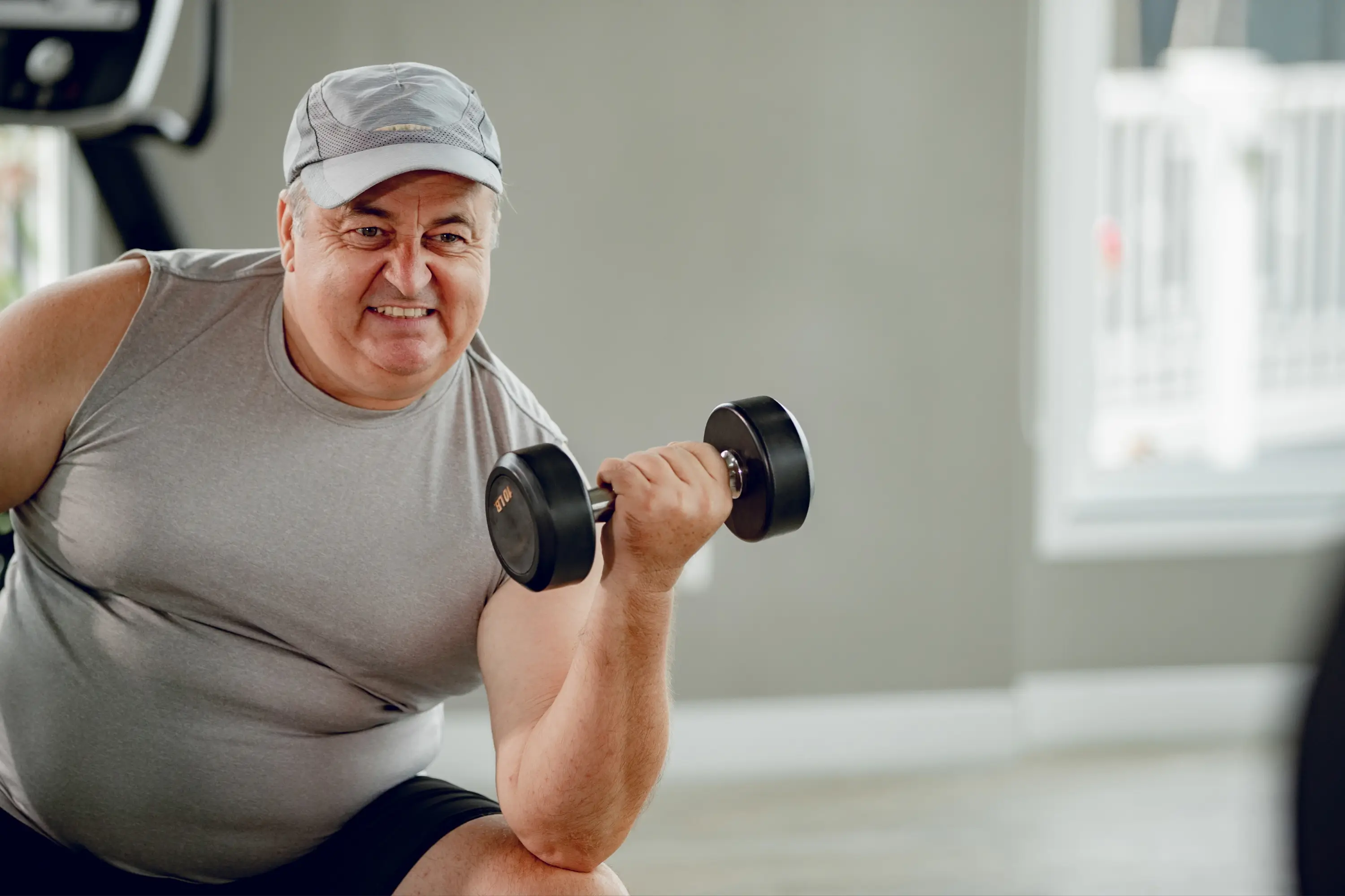 A man working out at the gym with a dumbbell