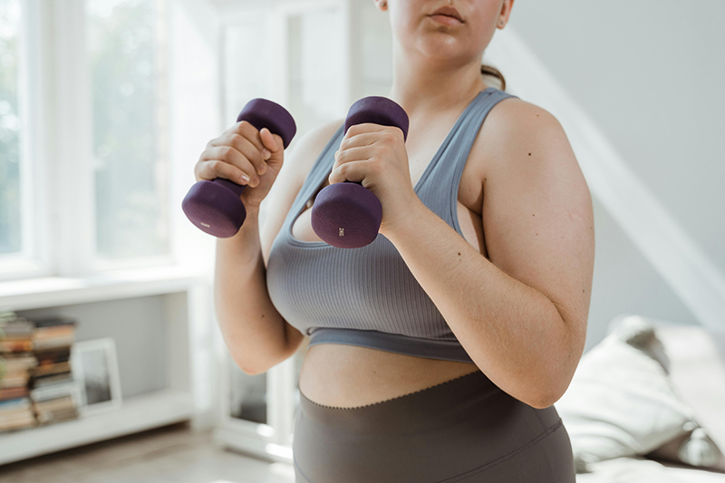 A woman lifting dumbbells