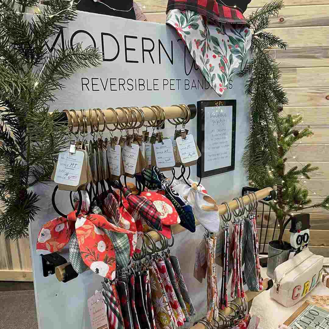 A vendor booth of handmade reversible pet bandanas at a holiday market at 14 Acres