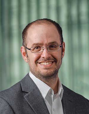 Chris Faulkner, Chief Technology Officer of Agilyx ASA, smiling in a professional headshot wearing glasses