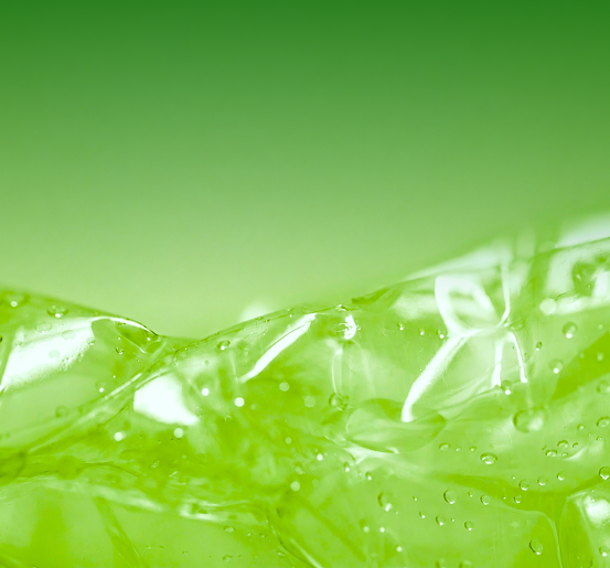 Close-up macro photograph of clear plastic film with water droplets, tinted green.