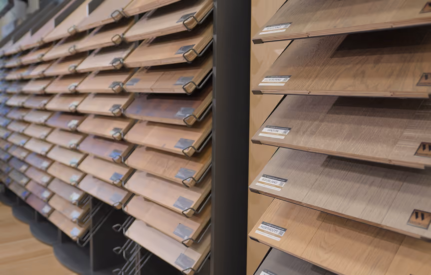 Wall display of hardwood flooring samples at the Flooring Services LLC Charleston showroom
