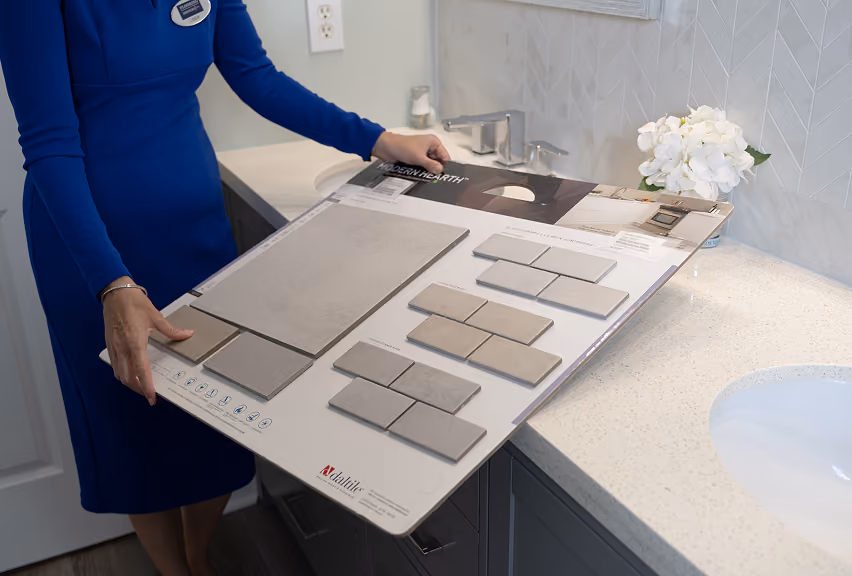 Flooring Services LLC showroom consultant presenting tile and stone samples to a customer