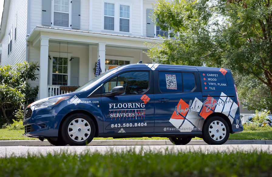Flooring Services LLC branded mobile showroom van parked outside a Charleston-area home