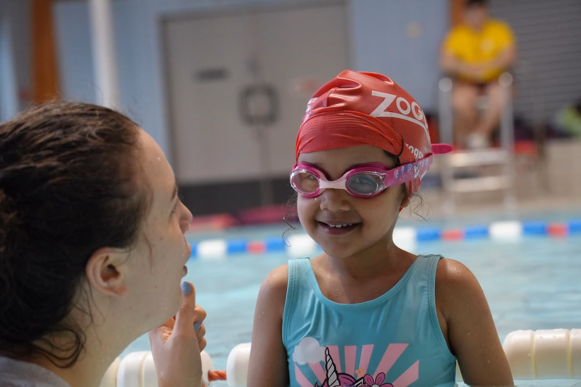Instructor with todler learning to swim.