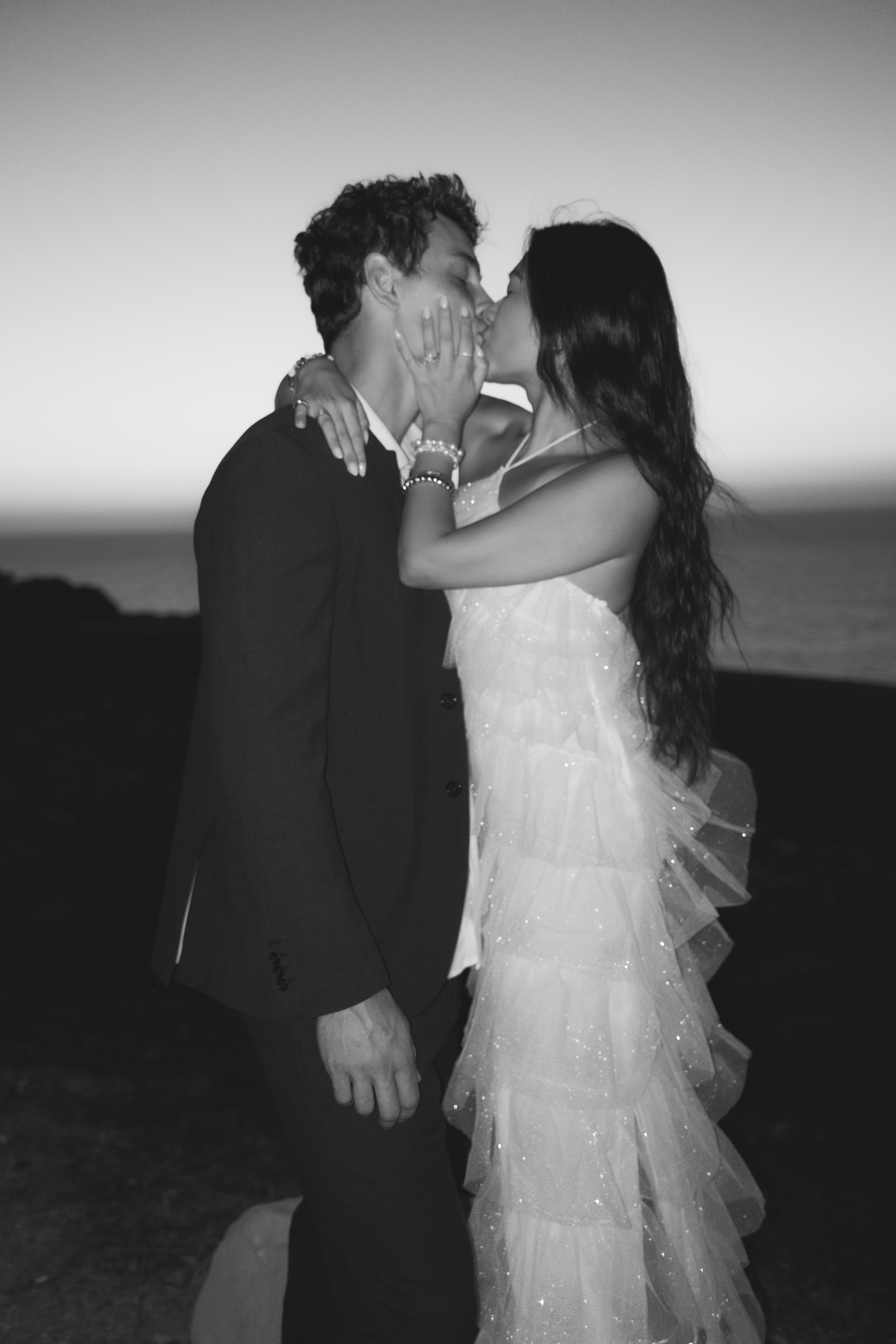 Black and white kiss at dusk by the ocean