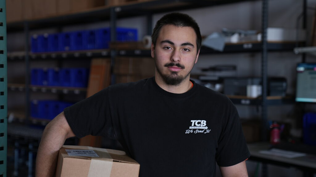 TCB fulfillment specialist working at an ecommerce packing station