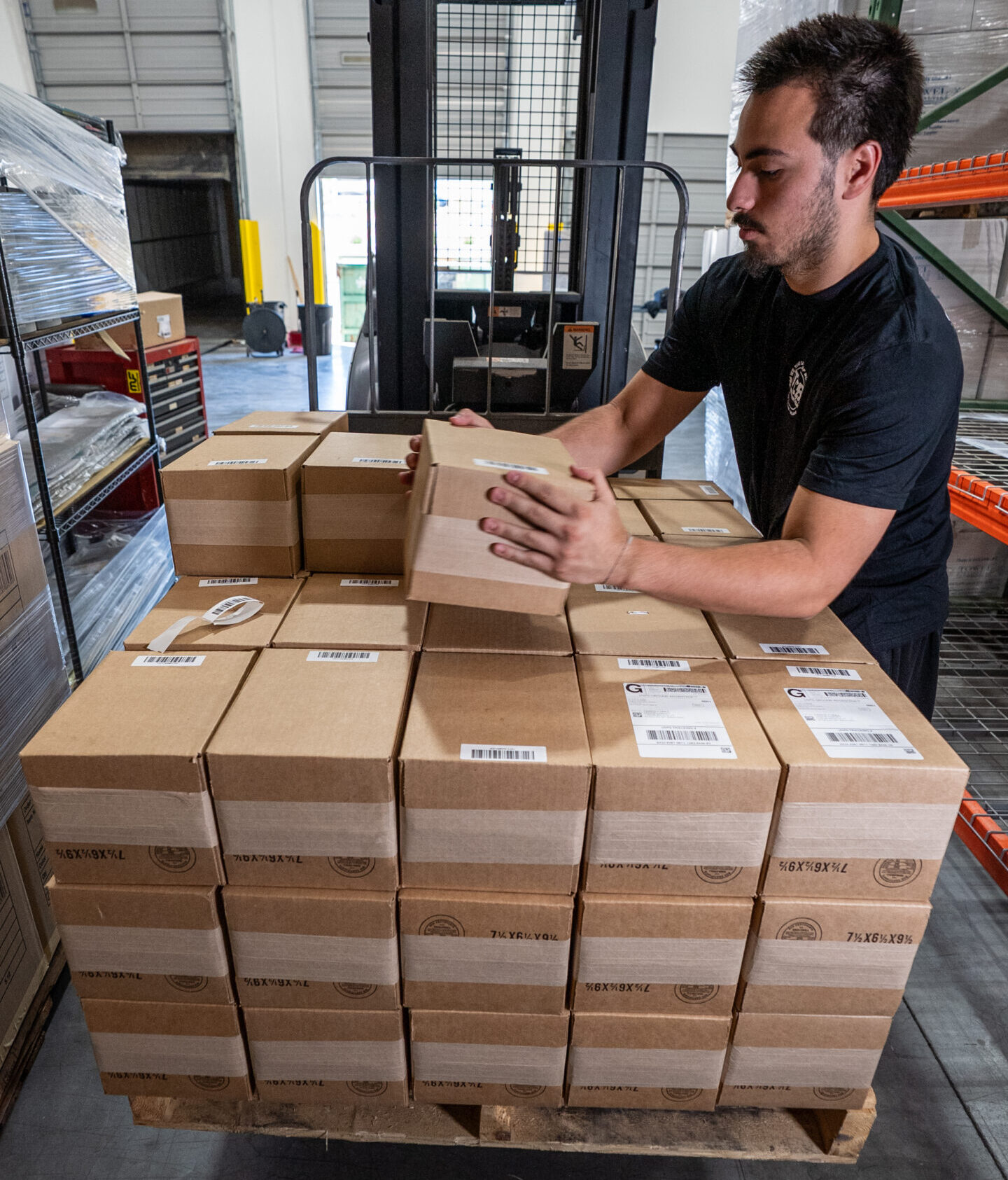 TCB fulfillment team member preparing ecommerce orders for shipment