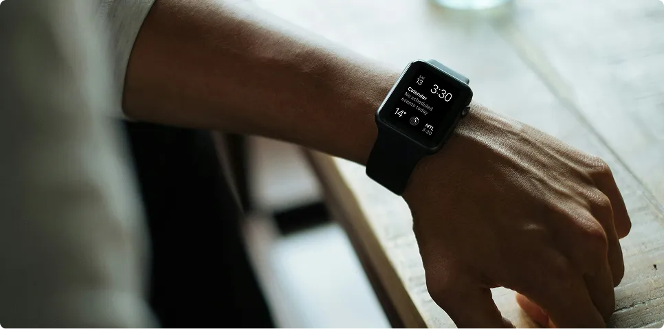 Close-up of a person wearing a modern black smartwatch displaying health monitoring metrics