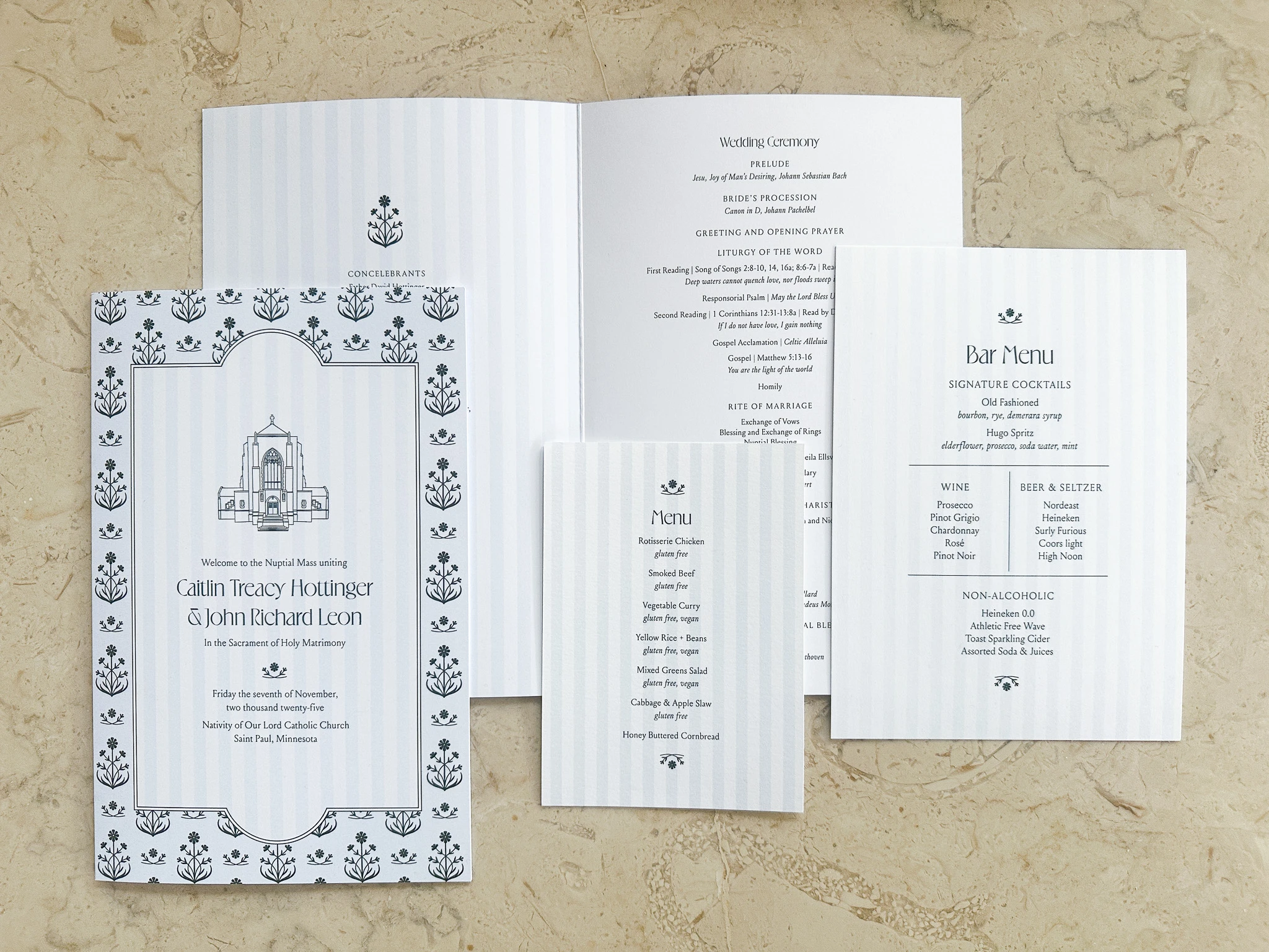 Wedding stationery set including a welcome card with floral border, a menu listing dishes like rotisserie chicken and vegetable curry, a bar menu with signature cocktails and wine selections, and a wedding ceremony program.