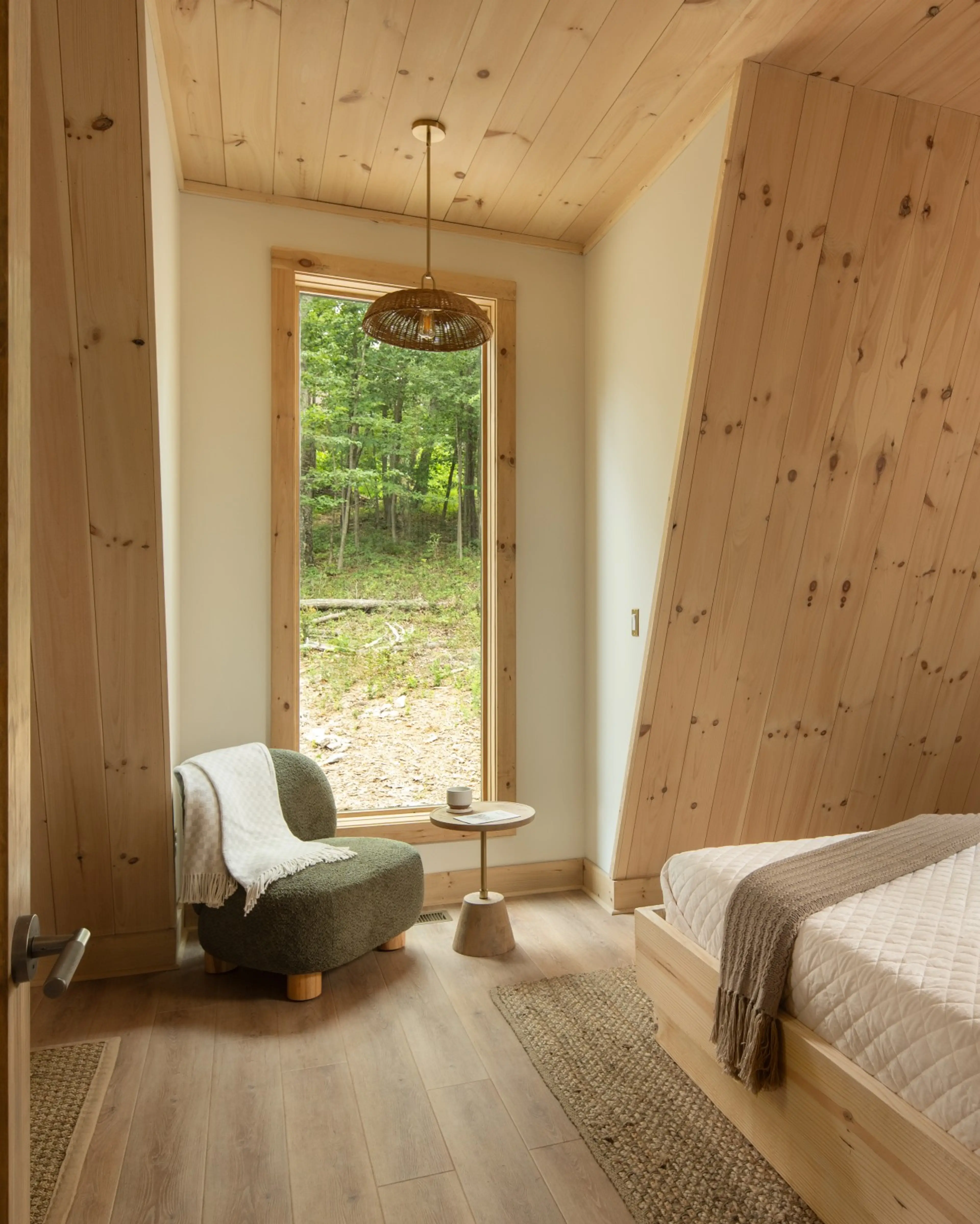 Bedroom at Solhaus Shenandoah with large windows overlooking the forest