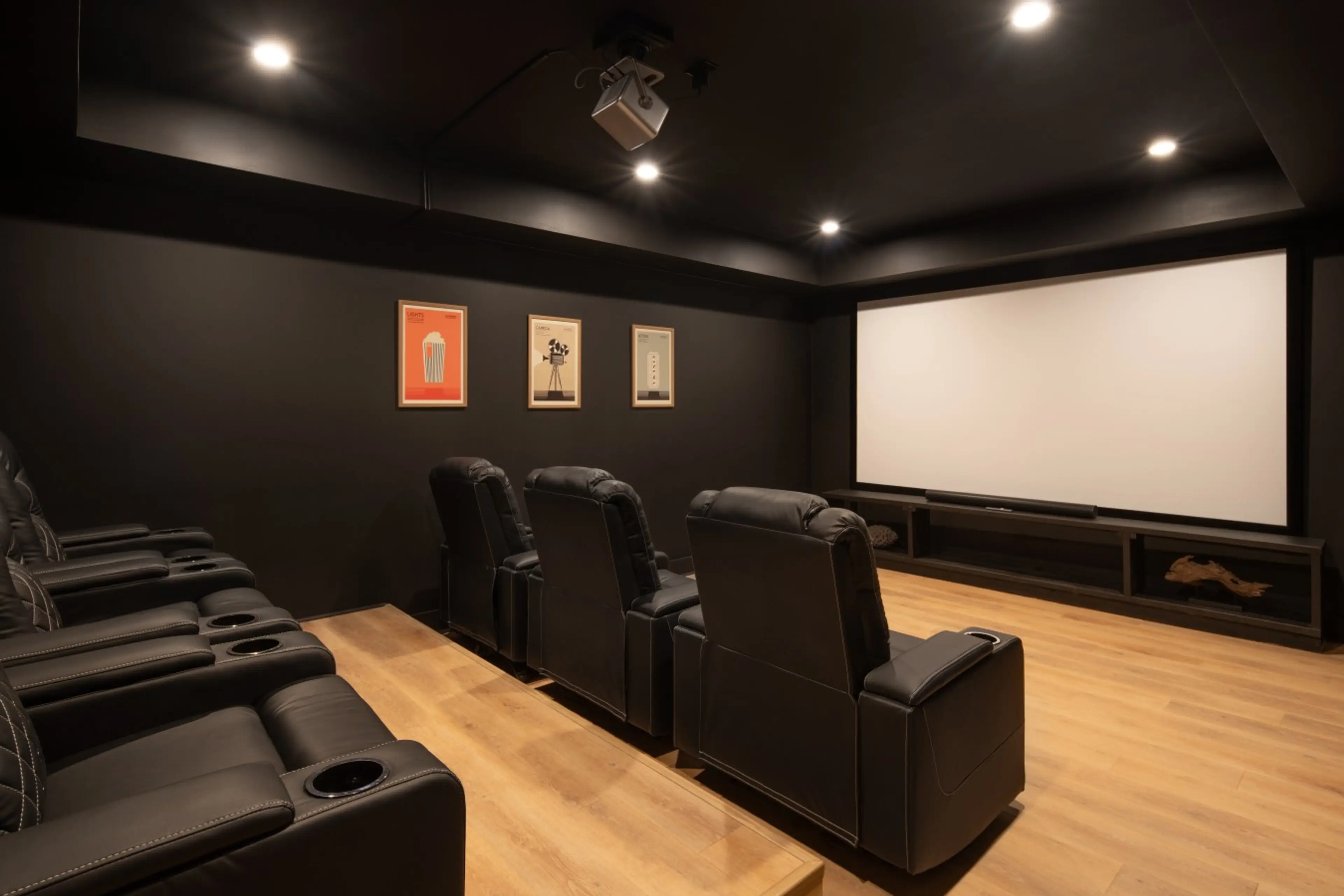 Home theater room at Solhaus Shenandoah with reclining seats and a large screen