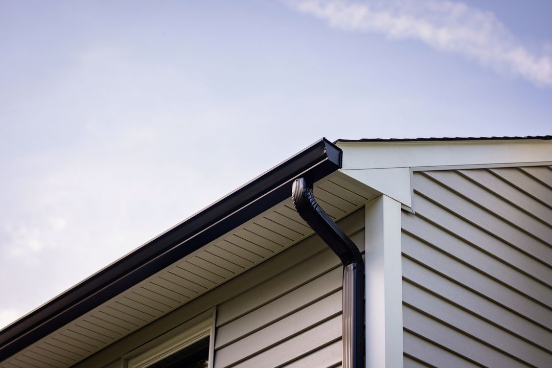 Black aluminum gutters and downspout on a Virginia home