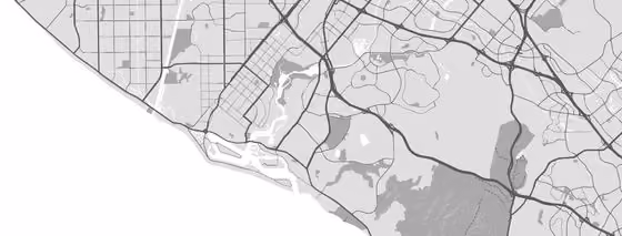 Grayscale map showing roads, waterways, parks, and neighborhoods in a coastal urban area with a grid street pattern inland and curving roads near the coast.