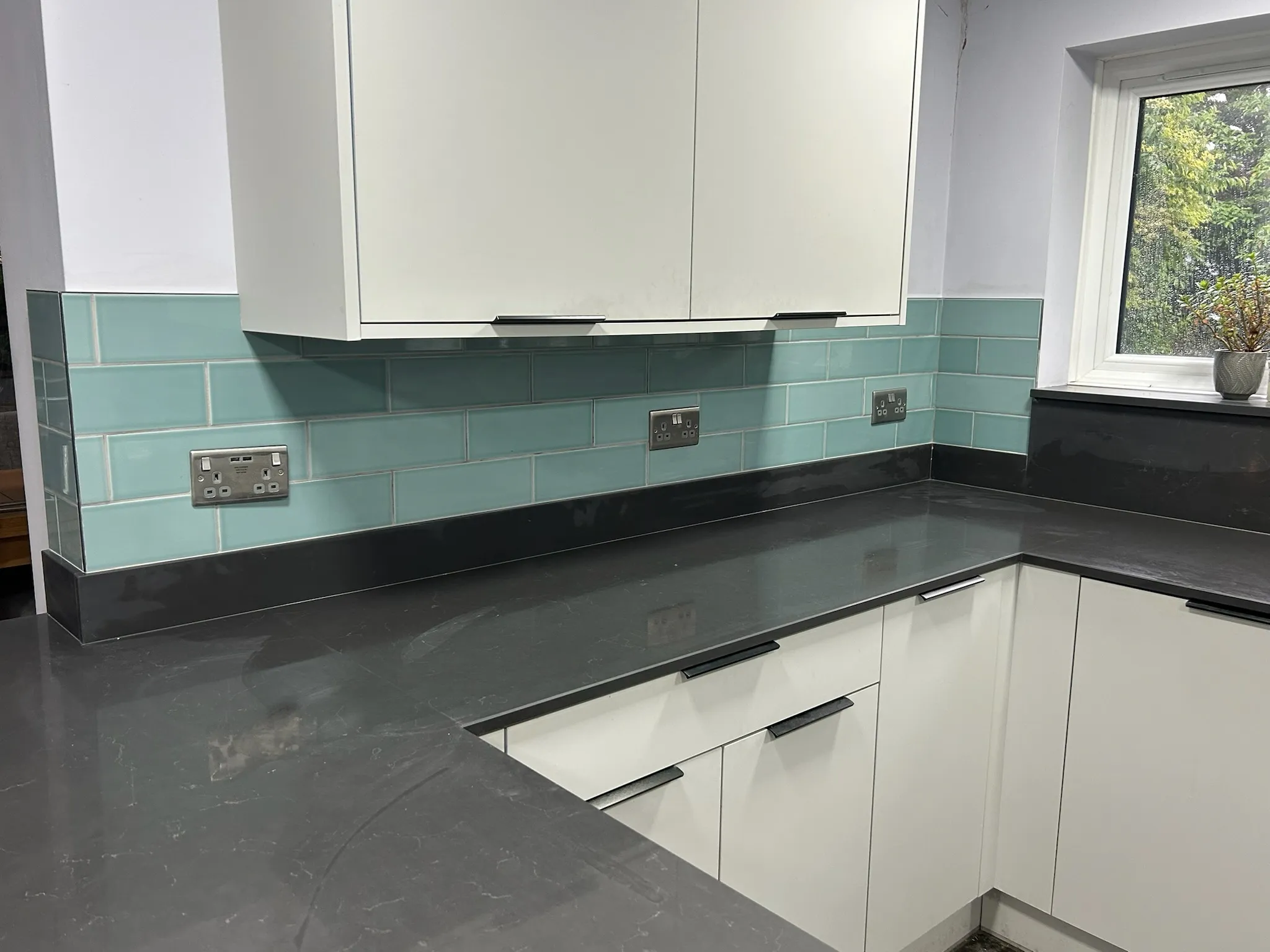 Green tiling in kitchen