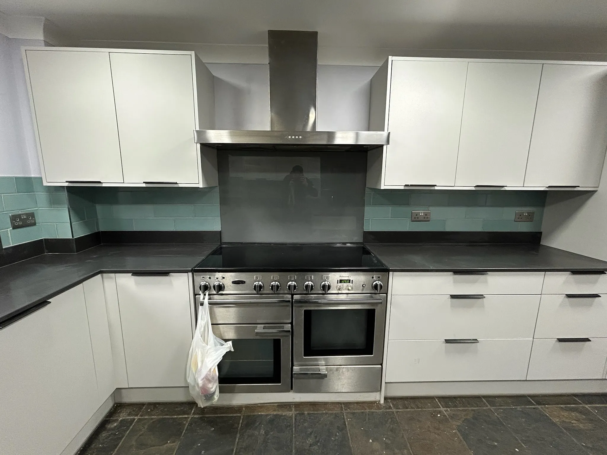 White kitchen with green tiling