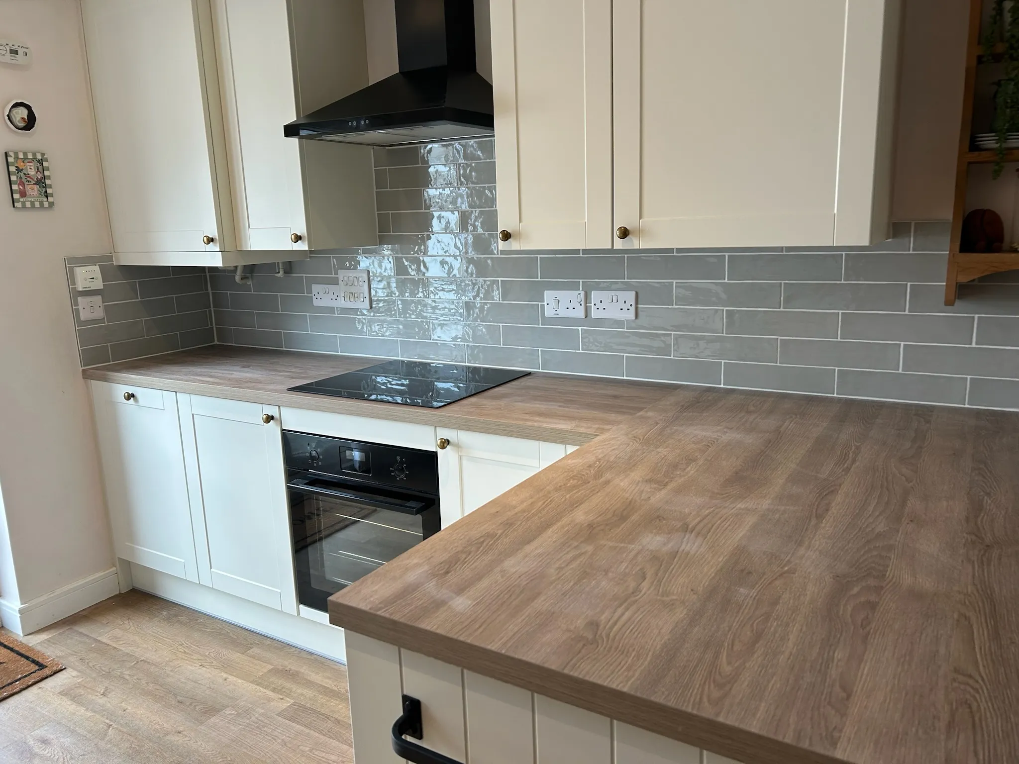 Grey tiling in white kitchen