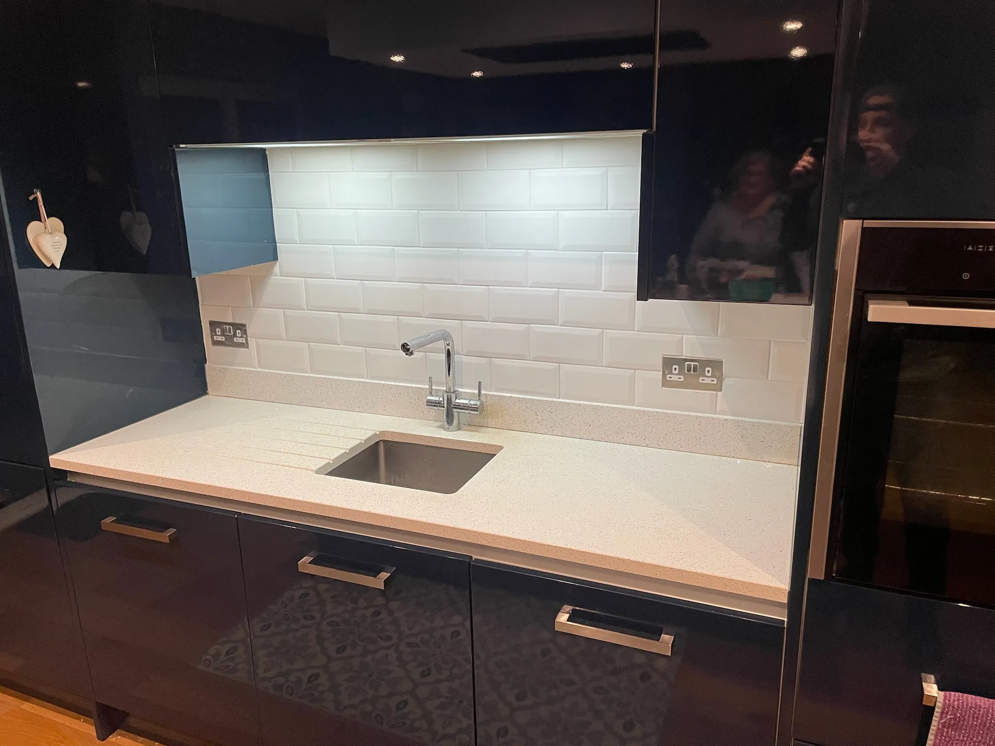 Navy kitchen with white tiling