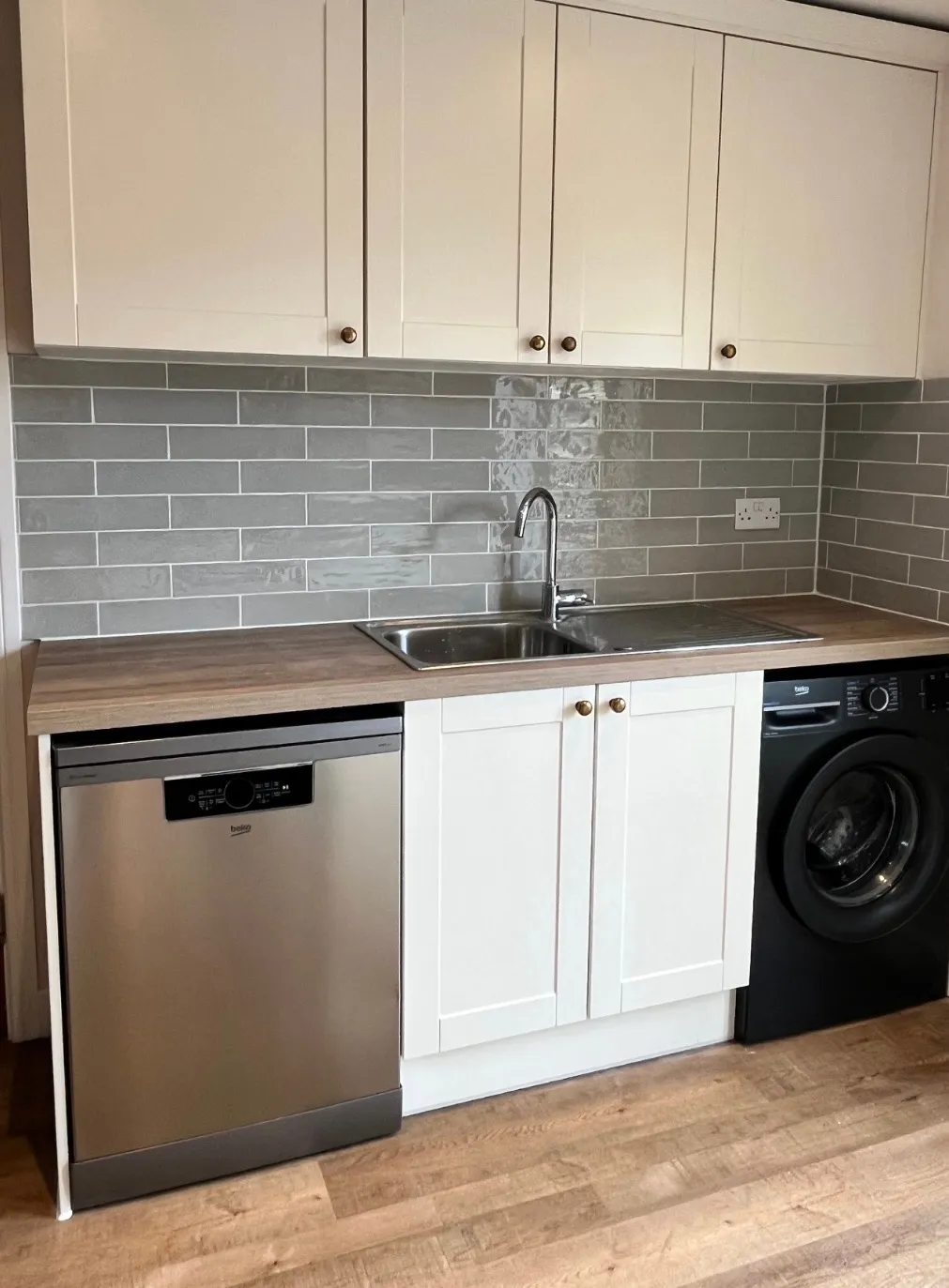 Grey tiling in new white bathroom
