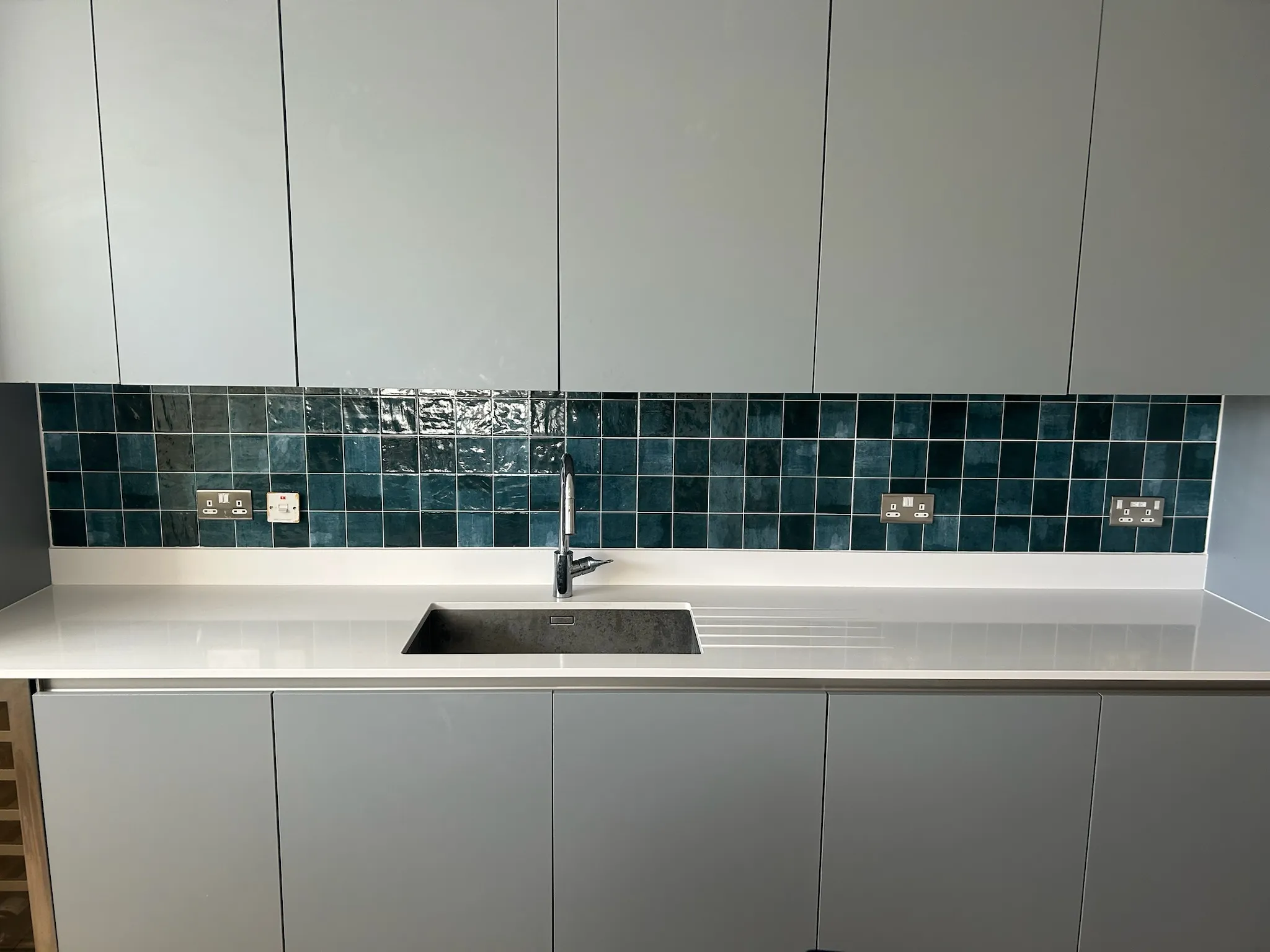 Grey kitchen with green tiles